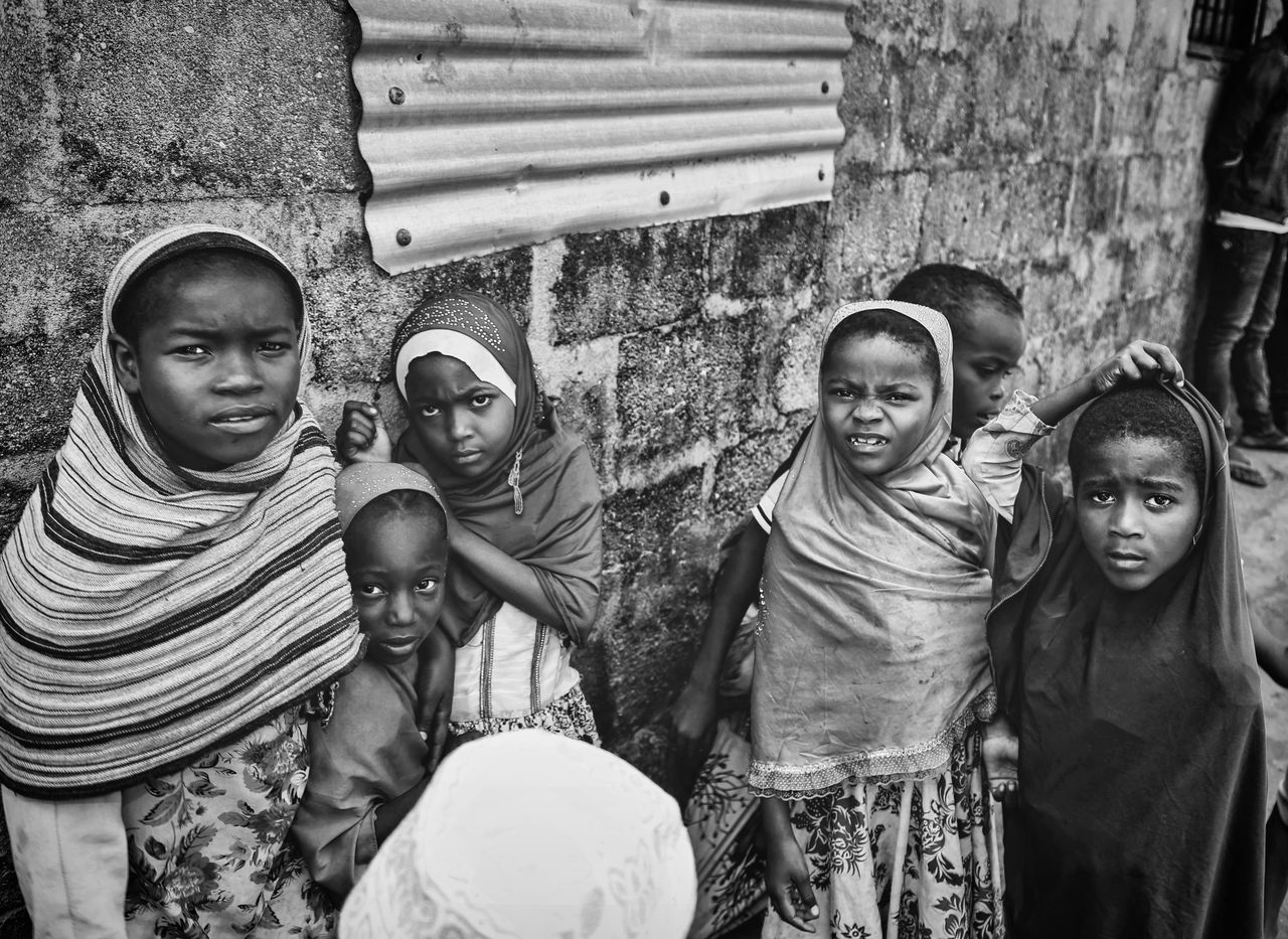 Black and white photograph of children in Zanzibar showcasing cultural attire.