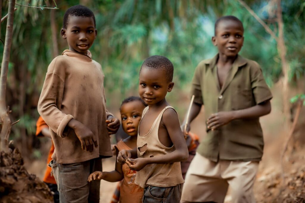 Smiling children playing outdoors in Bujumbura, Burundi, capturing joy and friendship.