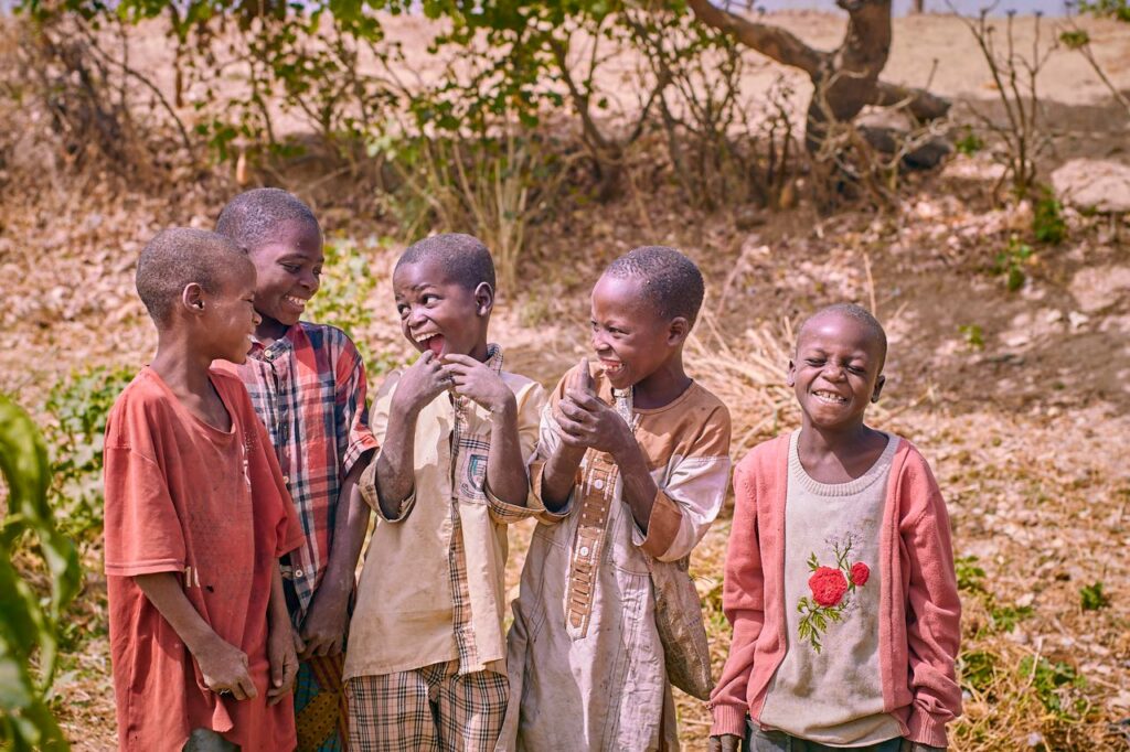A group of children laughing and enjoying a sunny day in nature. Heartwarming and joyful moment.